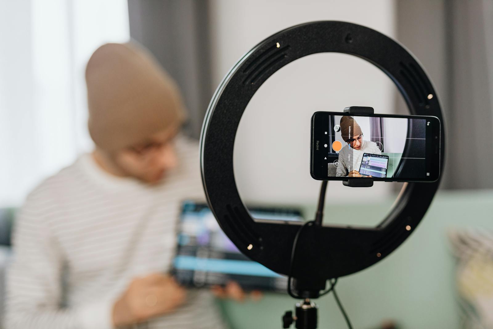 Creator filming content with a ring light and phone